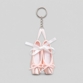 Fresh ballet pointe shoe keychain featuring small pale pink satin pointe shoes with white ribbon bows and a silver key ring