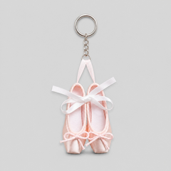 Fresh ballet pointe shoe keychain featuring small pale pink satin pointe shoes with white ribbon bows and a silver key ring