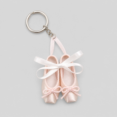 Ballet pointe shoe keychain featuring small pink satin shoes with pink bows and white ribbon tied in a bow