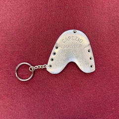 Tap Dance Keychain made from a worn silver metal tap with visible scuffs and 'Capezio Master Tap' embossed, attached to a small chain and ring