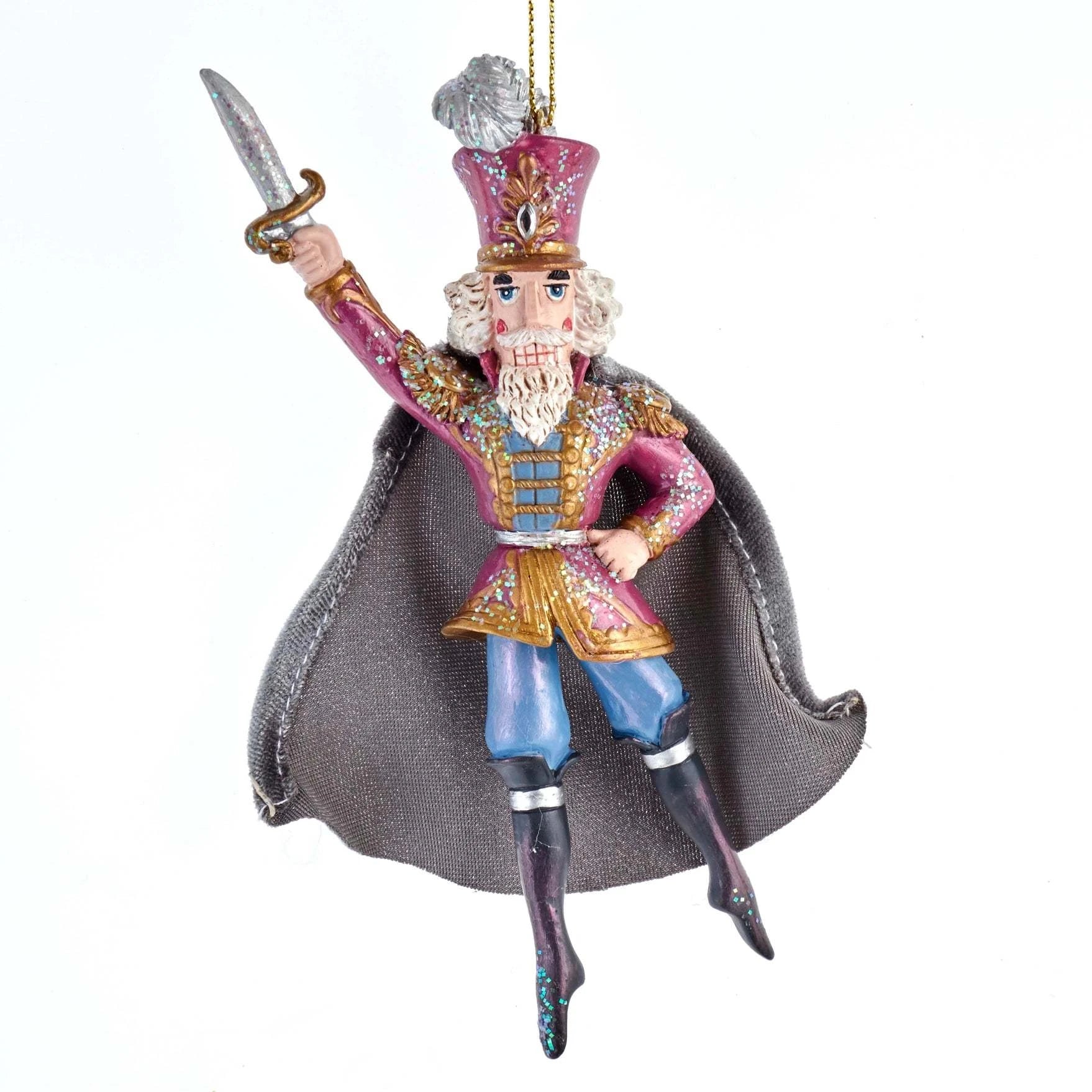 Kurt Adler E0426N Nutcracker Prince ornament in a pink uniform with a grey cape, hanging from a pink ribbon