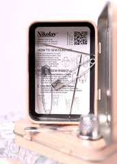 Premium sewing kit with needles, thread, scissors, and thimble in a tin