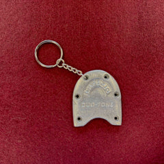 Tap Dance Keychain made from a silver metal tap with visible scuffs and wear, attached to a small chain and ring